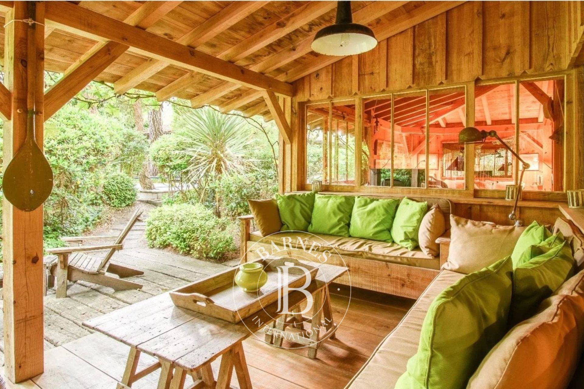 Salon lumineux avec cheminée dans une villa typique du Cap Ferret - Barnes Bassin d’Arcachon.