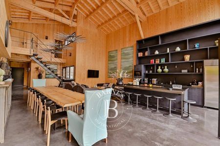 Cuisine ouverte avec îlot central et coin bar à Cap Ferret immobilier de luxe